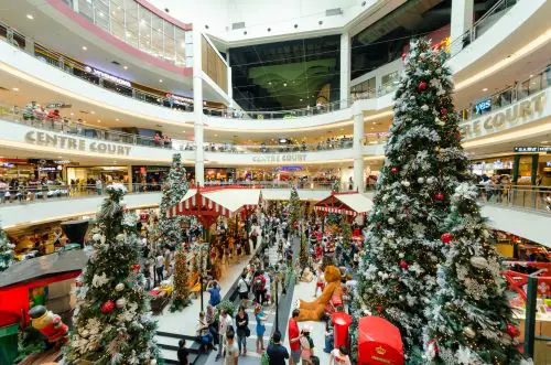 image of a busy mall with christmas trees and lineups