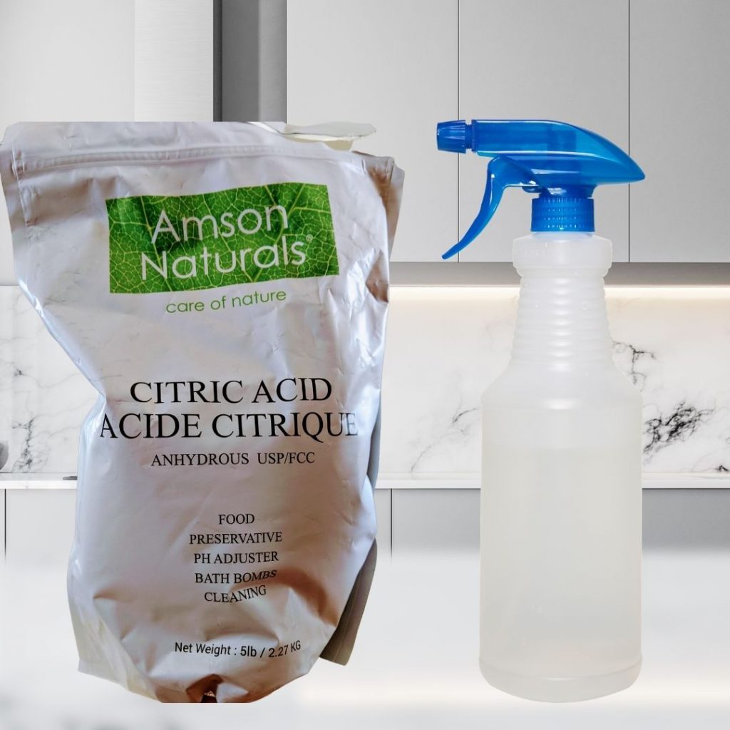 Image of spray bottle and bag of citric acid on countertop in all white kitchen to make all purpose cleaner