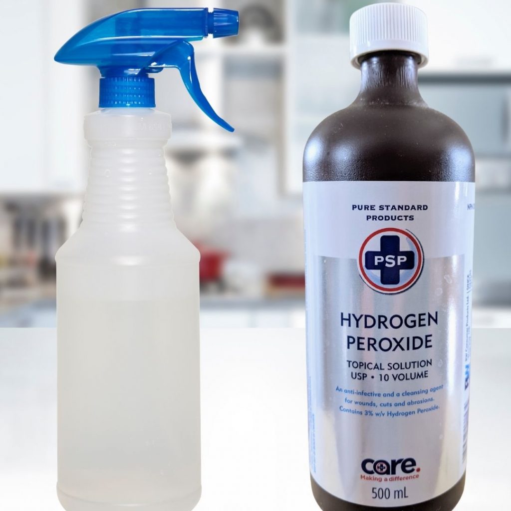 Image of hydrogen peroxide and spray bottle on countertop used to make your own disinfectant cleaner