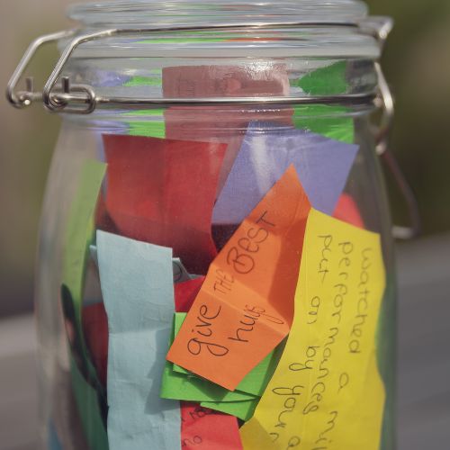 Glass jar with slips of paper inside