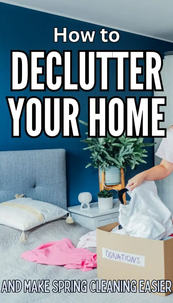 A person is organizing clothes near a bed with a blue wall, placing items into a box labeled "Donations," suggesting a spring declutter process related to home cleaning.