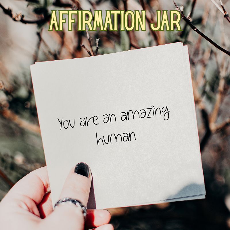 Image of hand holding a paper with an affirmation written on it for meaningful christmas gift ideas
 